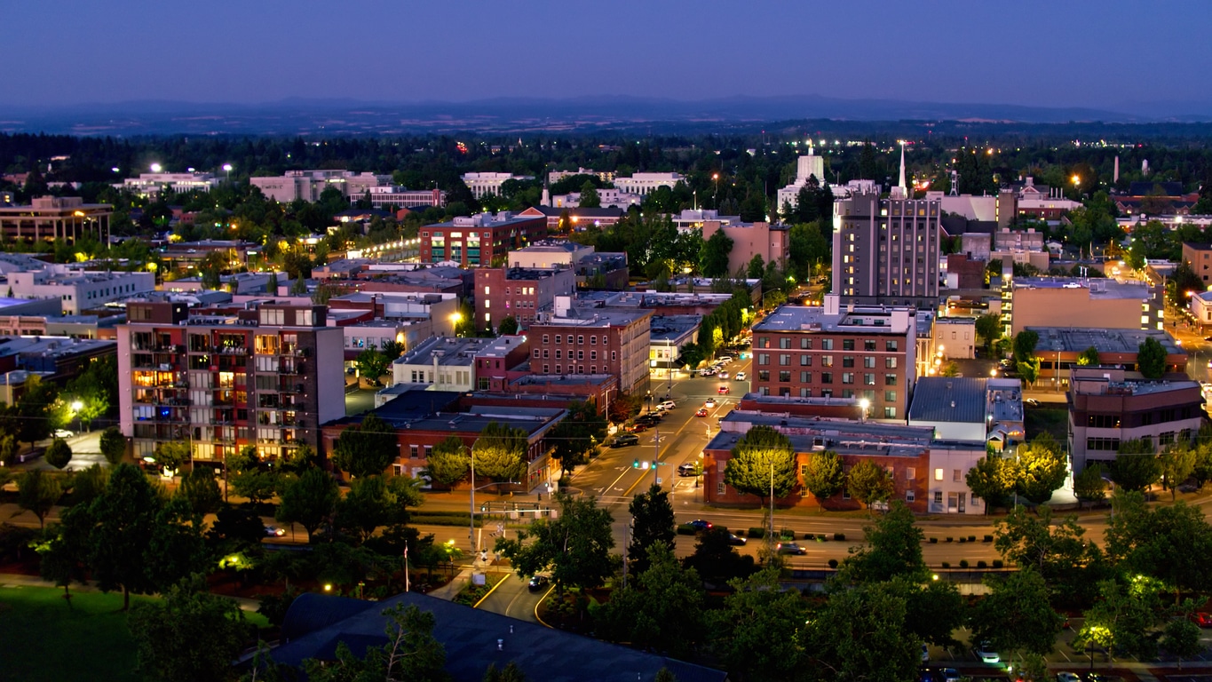 Aerial shot of Salem, Oregon on a summer night, looking along State Street towards the Oregon State Capitol Building.
